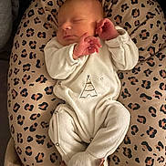Maxence participe au concours pour gagner de l'argent avec cette photo : baby, newborn, sleeping, onesie, animal_print, cushion, leopard_print, soft_lighting, infant, cozy, cute, peaceful, portrait, child, resting, indoor, plush, white_clothing, hands, face