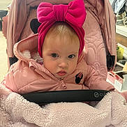 Jasmin joined the competition — help win amazing prizes! baby, child, stroller, pink_jacket, headband, bow, blanket, face, portrait, infant, cute, winter_clothing, cozy, indoor, person, expression, seated, soft_texture, warm, baby_accessory