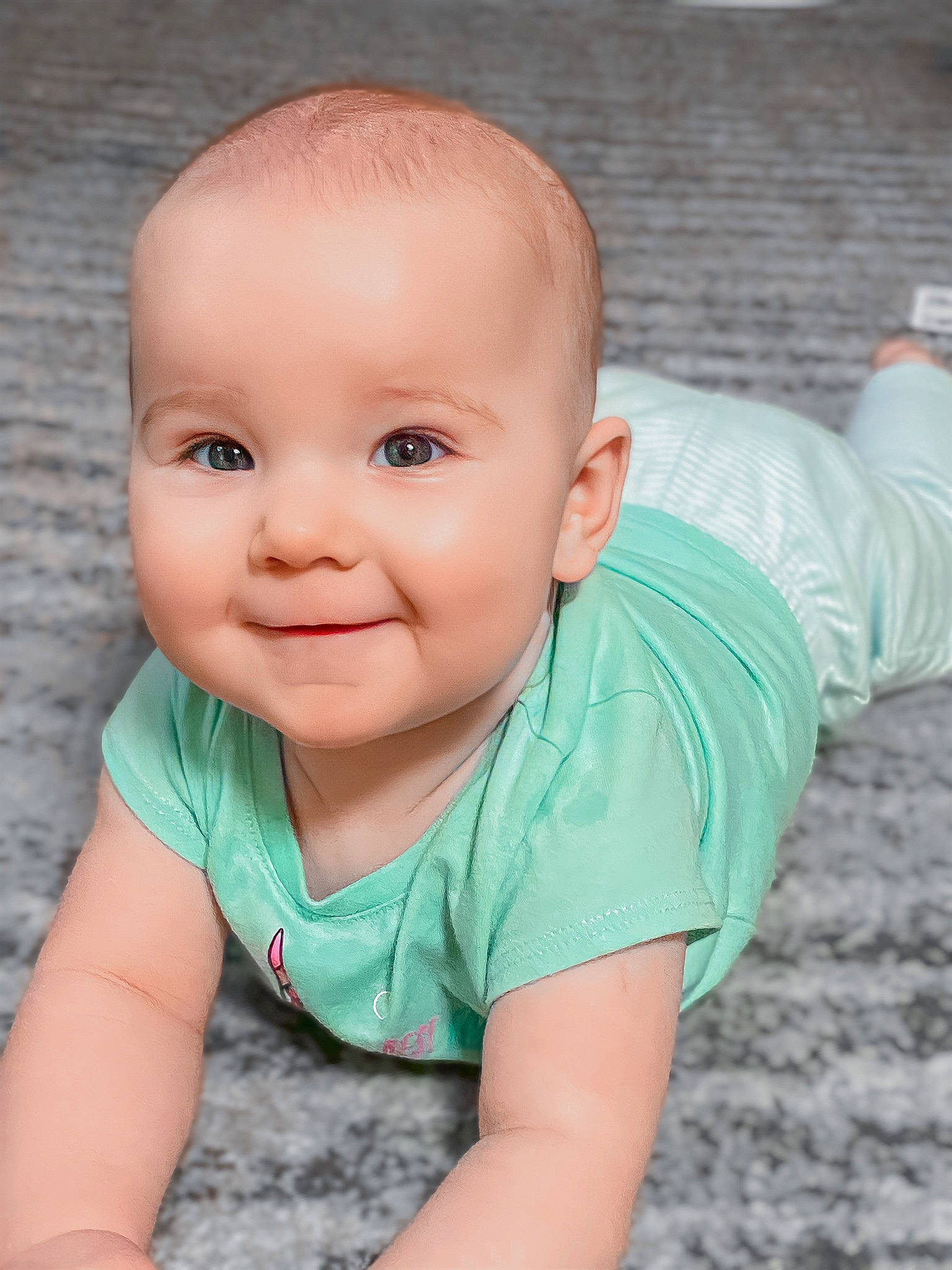 Everleigh is registered to the contest to win money with this photo: baby, baby_toddler_clothing, cheek, child, chin, eye, face, head, joy, lip, nose, person, photography, portrait, portrait_photography, skin, smile, toddler, tummy_time
