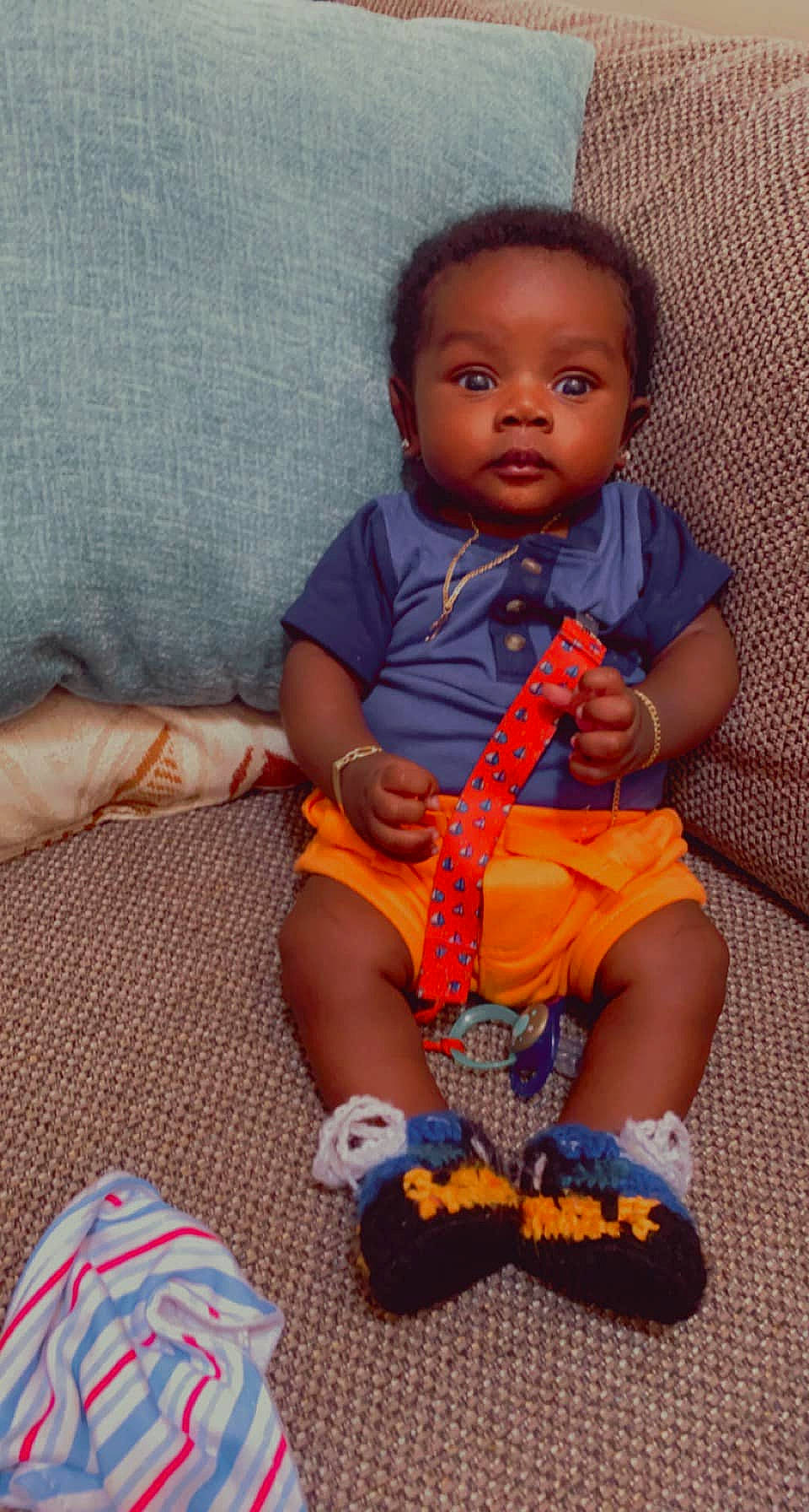 Cannon is registered to the contest to win money with this photo: arm, baby, baby_products, baby_toddler_clothing, child, electric_blue, finger, flooring, fun, hairstyle, happy, leg, nail, pattern, person, sitting, skin, smile, textile, toddler