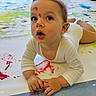 child, toddler, face_paint, paint, hands, floor, indoor, curious, expression, art, messy, colorful, clothing, long_sleeve, baby, play, creative, exploration, skin, person