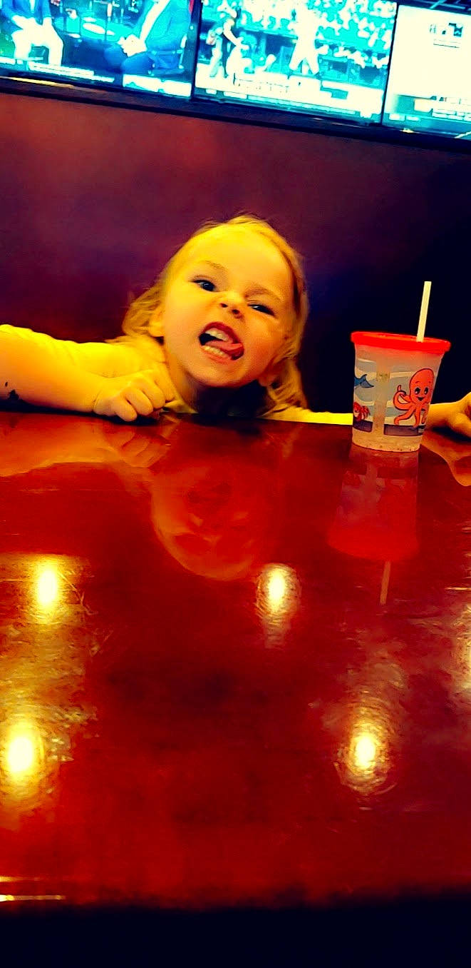 Chevelle is registered to the contest to win money with this photo: baby, bathing, child, entertainment, event, finger, flooring, food, fun, happy, hardwood, orange, performance_art, performing_arts, person, play, smile, sweetness, toddler, water