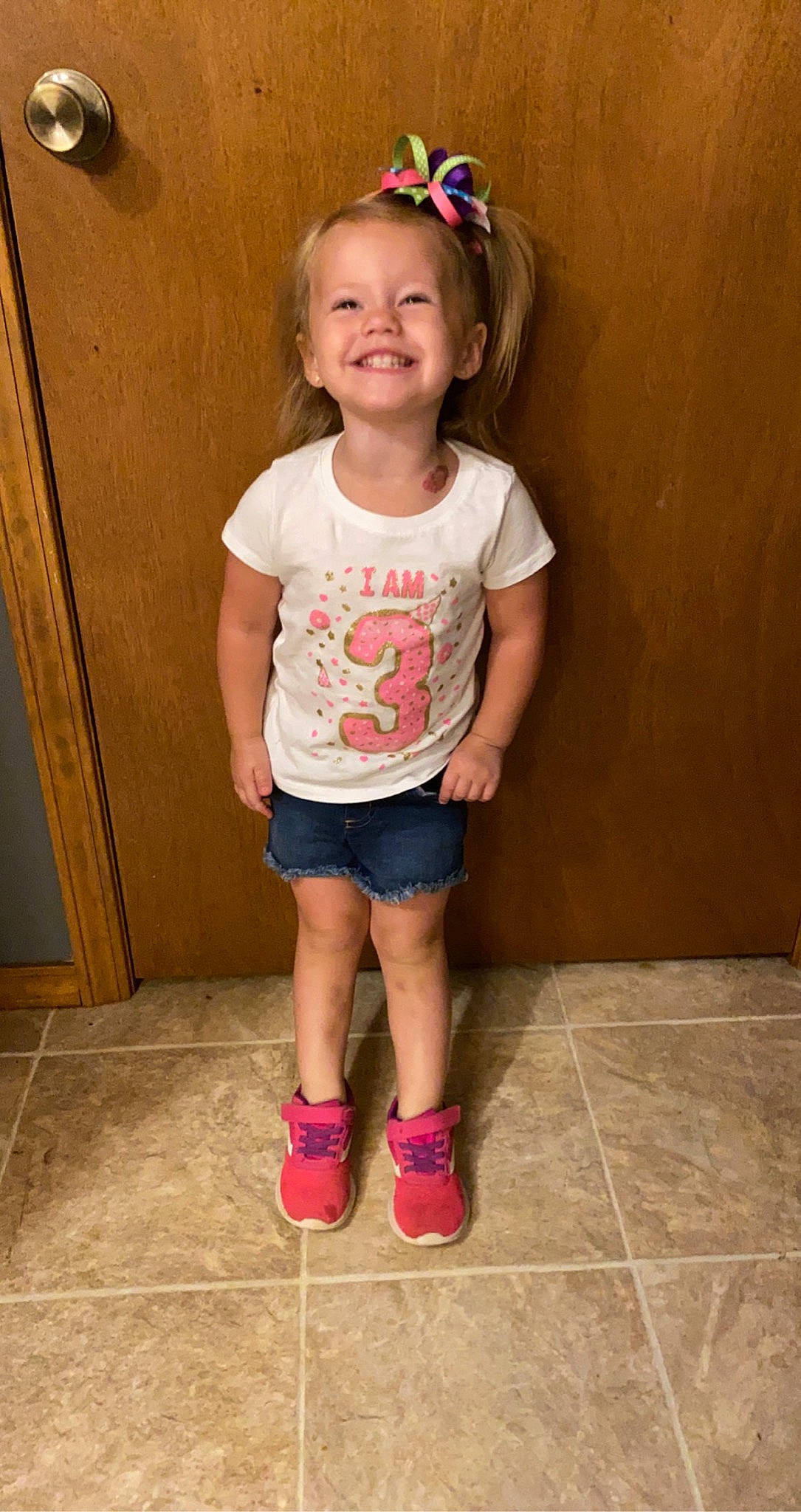 Karli is registered to the contest to win money with this photo: child, child_model, footwear, fun, joy, leg, person, pink, shoe, shorts, shoulder, smile, standing, t_shirt, toddler