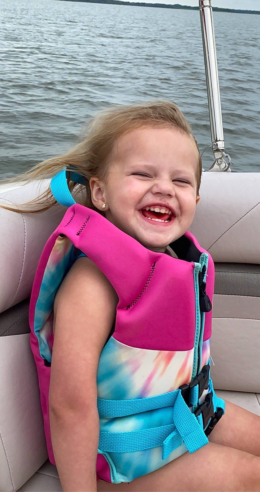 Karli is registered to the contest to win money with this photo: boating, car_seat, child, fun, joy, lifejacket, neck, person, personal_protective_equipment, recreation, smile, toddler, vacation, wetsuit