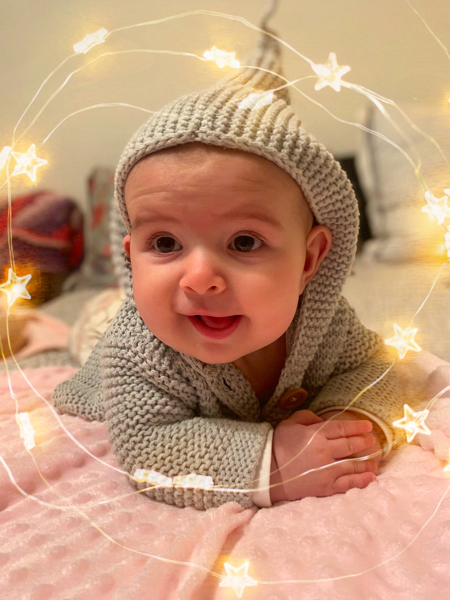 Alexandra is registered to the contest to win money with this photo: baby, baby_toddler_clothing, cheek, child, christmas, event, eye, fashion_accessory, flooring, fun, happy, headwear, holiday, interior_design, ornament, pattern, person, portrait_photography, smile, toddler