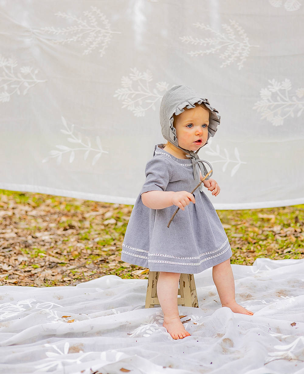Charlotte is registered to the contest to win money with this photo: baby_toddler_clothing, child, day_dress, dress, fashion_accessory, fashion_design, fawn, formal_wear, fun, grass, happy, headpiece, headwear, linens, one_piece_garment, pattern, peach, people_in_nature, person, sleeve