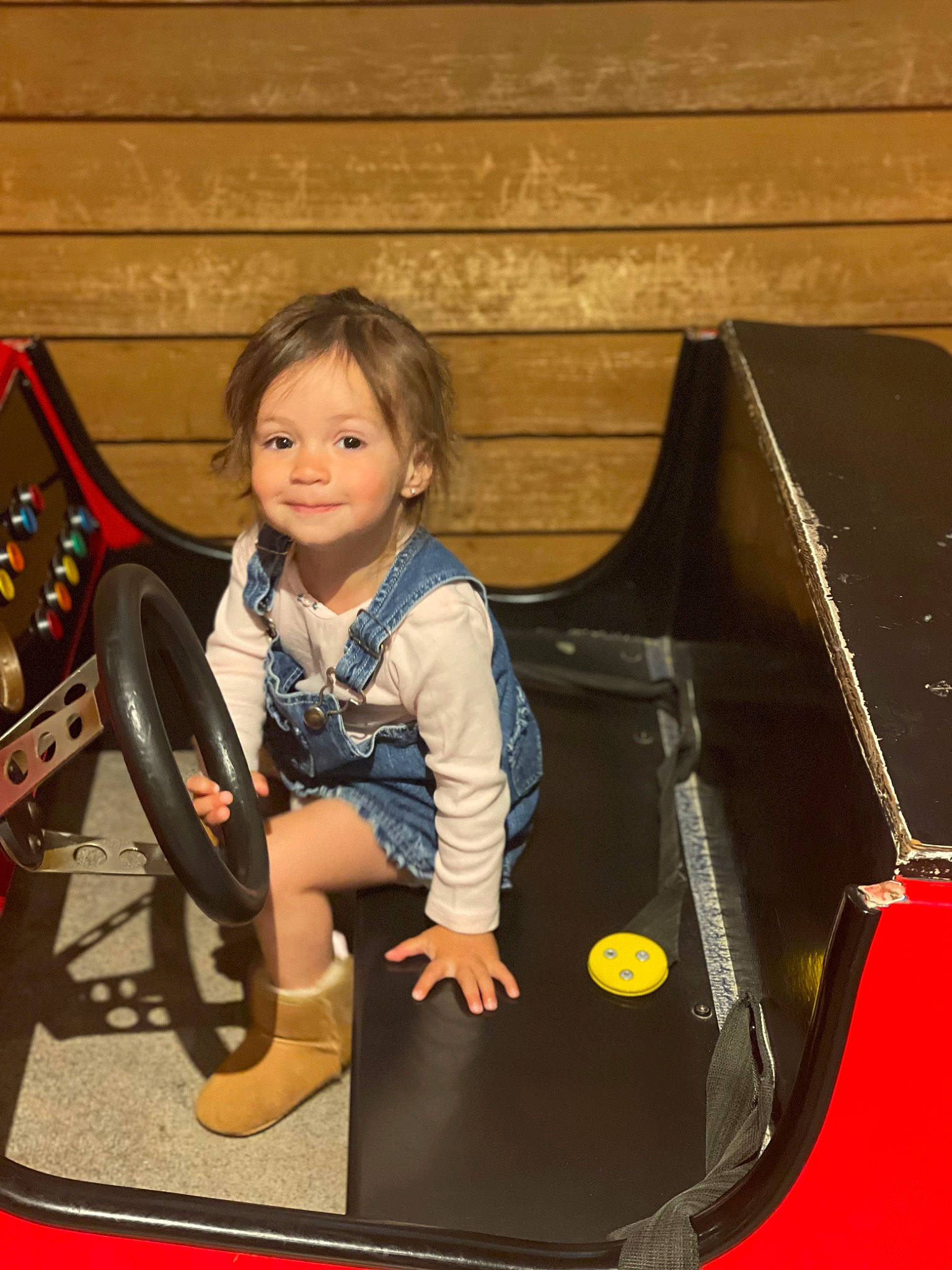 Maeve is registered to the contest to win money with this photo: automotive_exterior, bumper, chair, child, electric_blue, flash_photography, fun, joy, leisure, motor_vehicle, person, play, recreation, sitting, smile, t_shirt, toddler, vehicle_door, wood