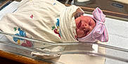 Kaia joined the competition — help win amazing prizes! newborn, baby, hospital, bassinet, blanket, hat, bow, sleeping, infant, swaddled, bed, person, cute, pink, blue, white, soft, resting, newborn_baby, healthcare