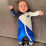 Omar participe au concours pour gagner de l'argent avec cette photo : baby, blue_jumpsuit, casual_wear, child, clothing, couch, cute, face, footwear, home_interior, indoors, infant, lying_down, nike, person, shoes, sneakers, socks, stretching, young