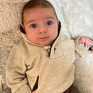 Omar participe au concours pour gagner de l'argent avec cette photo : baby, beige_clothing, blanket, blue_eyes, casual, child, closeup, cozy, cute, face, hand, hoodie, indoor, infant, portrait, relaxed, soft_texture, stuffed_animal, warm_clothing, young_child