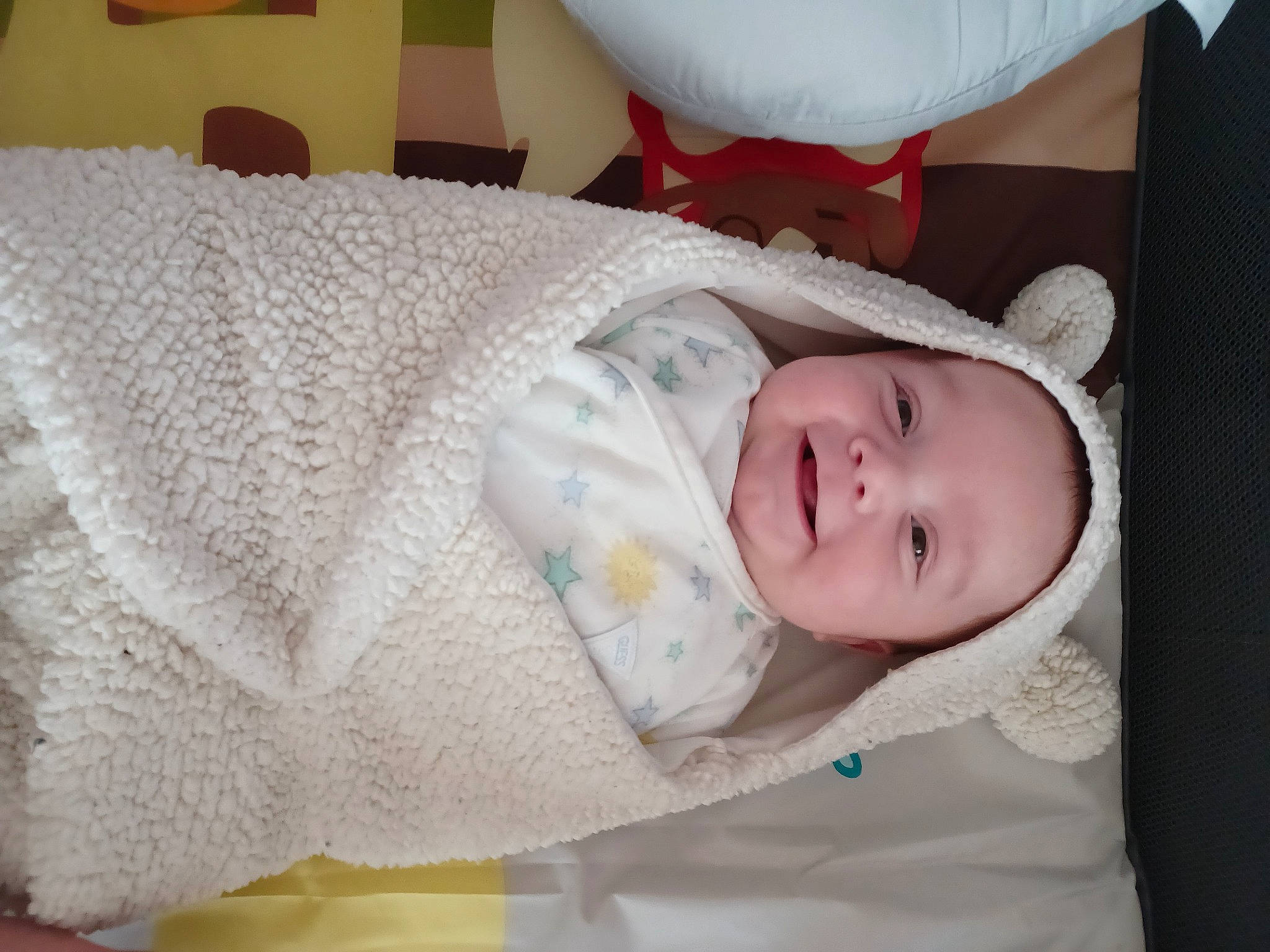 Maverick is registered to the contest to win money with this photo: baby, baby_products, baby_toddler_clothing, cheek, child, comfort, eyelash, joy, linens, lip, pattern, person, product, room, skin, sleeve, smile, textile, toddler