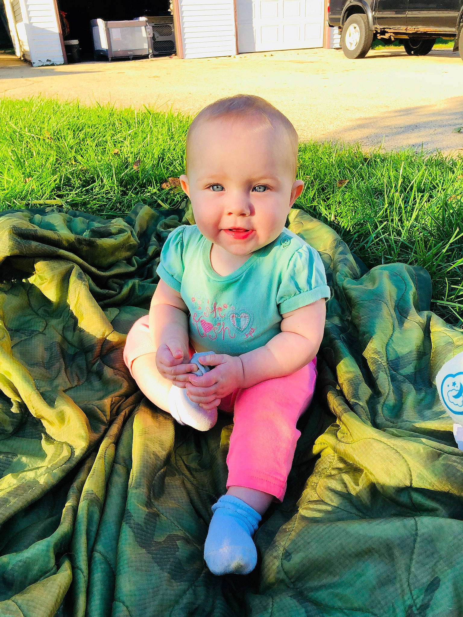Daphne is registered to the contest to win money with this photo: boy, child, eye, fun, girl, grass, infant, person, plant, play, product, sitting, skin, smile, toddler, vacation