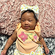 Alaiah joined the competition — help win amazing prizes! baby, blanket, bow, child, clothing, cute, flower, fruit, headband, indoors, infant, lying_down, pacifier, pattern, peach, pineapple, pink, smiling, soft_texture, strawberry