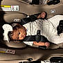 Alaiah is registered to the contest to win money with this photo: baby, baby_girl, black_hair, car_seat, child, clothing, cute, headband, indoor, infant, infant_care, person, restraint, safety_belt, seat, seatbelt, small_person, soft_lighting, warning_label, white_clothing