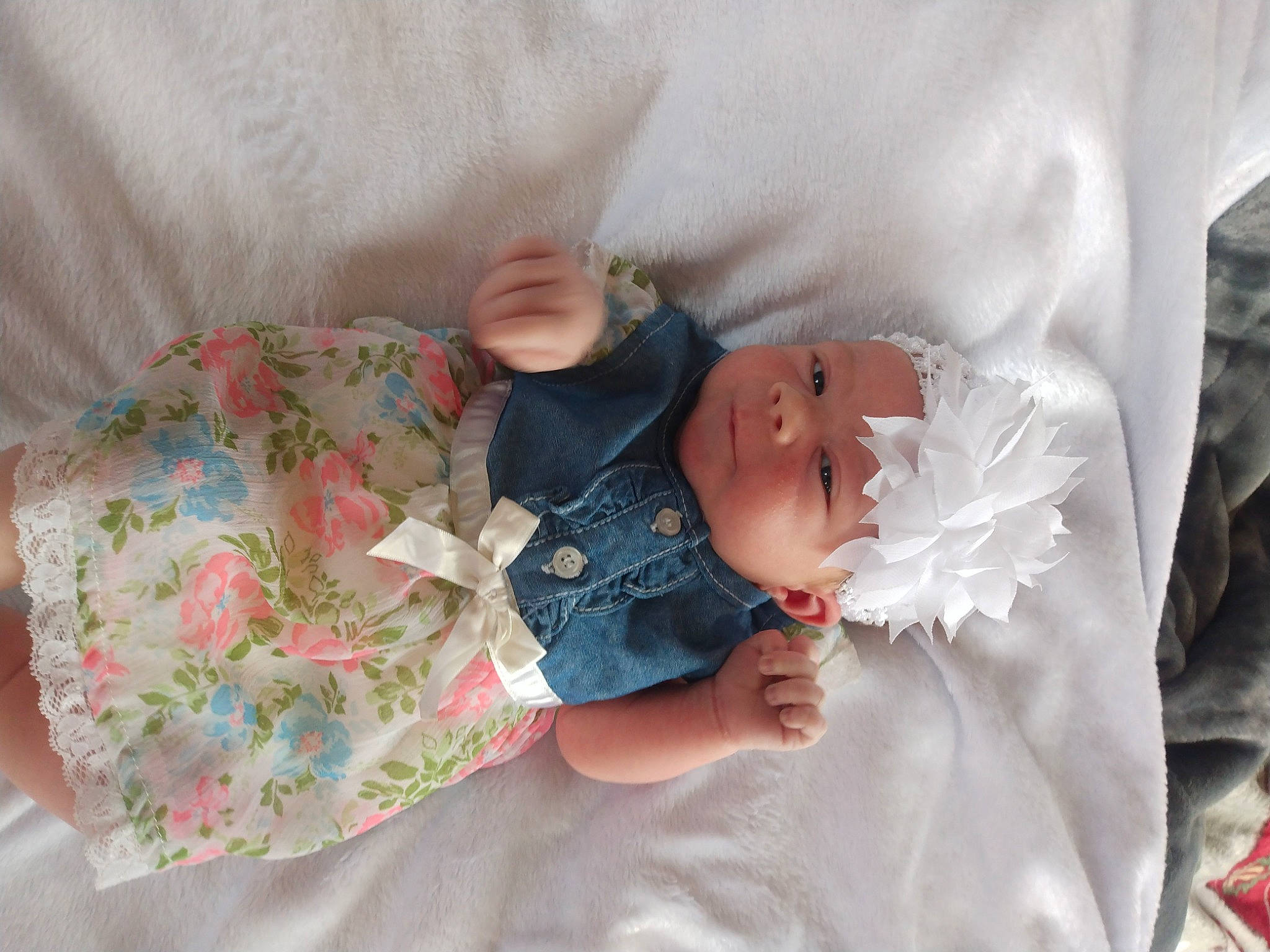 Sierra is registered to the contest to win money with this photo: baby, baby_products, baby_toddler_clothing, child, comfort, dress, eye, finger, hand, hat, headwear, human_body, leg, linens, pattern, person, room, skin, sleeve, textile