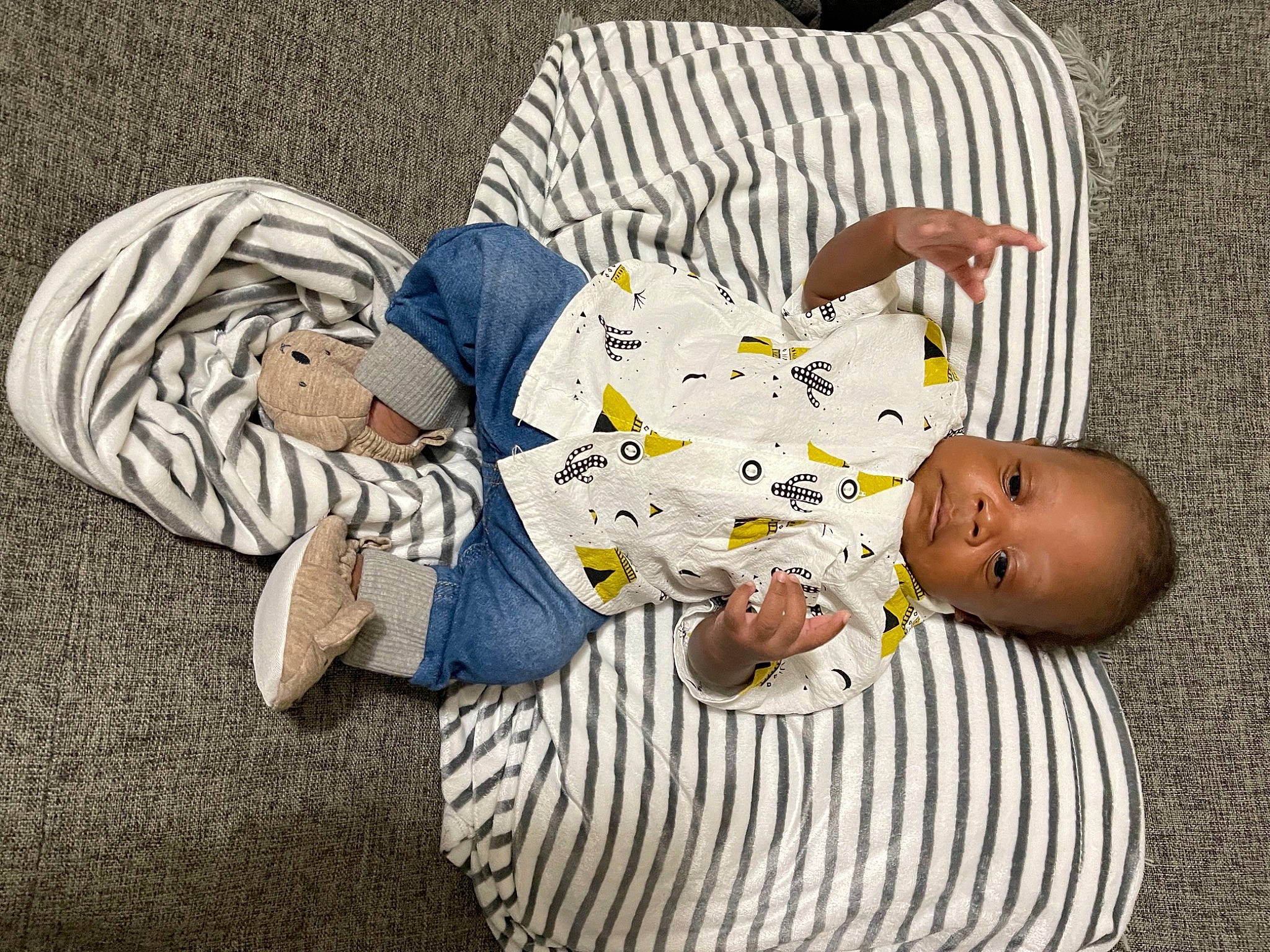 Mikel joined the competition — help win amazing prizes! arm, baby, baby_toddler_clothing, child, comfort, facial_expression, flooring, foot, grass, hairstyle, hand, human, human_body, joint, leg, person, sitting, sleeve, textile, toddler