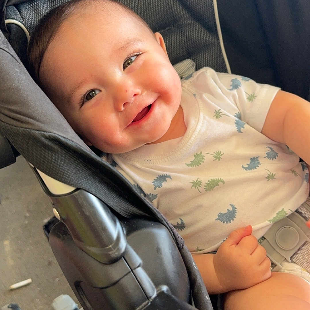 Waylon joined the competition — help win amazing prizes! accessories, baby, bed, bodypart, clothing, cushion, face, finger, furniture, hand, happy, head, homedecor, person, photography, portrait, smile, strap, stroller, t_shirt