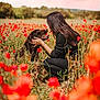 woman, dog, field, flowers, poppies, nature, outdoor, love, affection, pet, animal, grass, crouching, happy, smiling, daylight, casual_clothing, long_hair, red_flowers, greenery