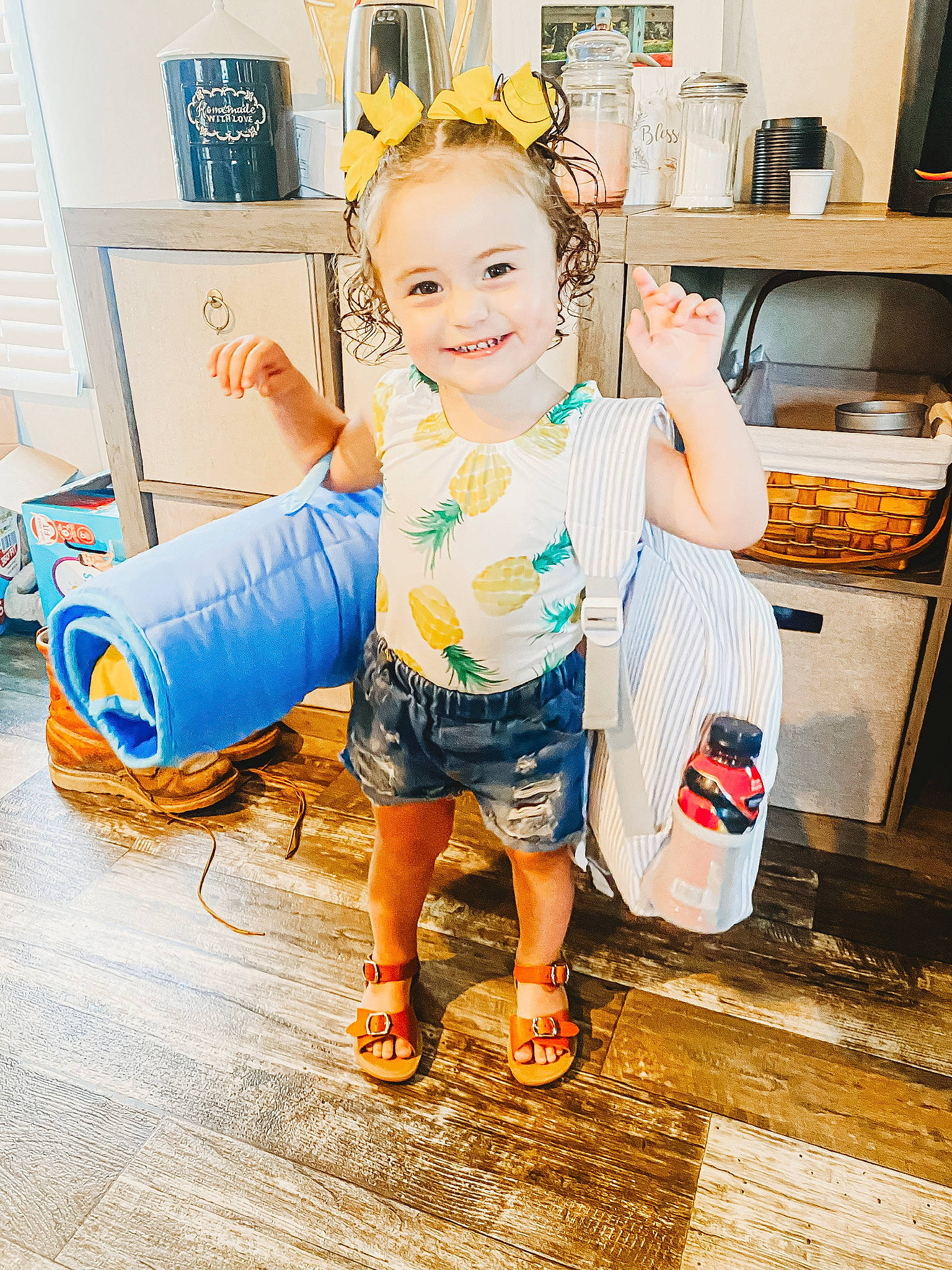 Sara is registered to the contest to win money with this photo: child, cooking, electric_blue, eye, flooring, fun, happy, home_appliance, human_leg, joy, kitchen, kitchen_appliance, leisure, person, play, refrigerator, room, sandal, shorts, smile