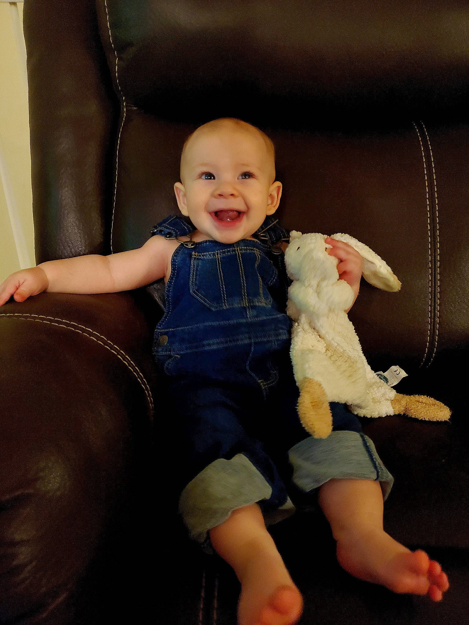 Aydan is registered to the contest to win money with this photo: arm, baby, chair, cheek, child, eye, family, finger, fun, furniture, leg, person, play, sitting, skin, smile, standing, toddler