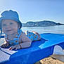 Lewis participe au concours pour gagner de l'argent avec cette photo : baby, beach, bear_print, blue_hat, child, infant, lounge_chair, mountain, outdoor, relaxation, sand, sea, sky, smiling, striped_onesie, summer, sunlight, sunshine, vacation, water