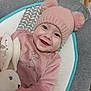 Alba a rejoint le concours — aidez-le/la à gagner de superbes lots ! baby, baby_seat, bunny, child, clothing, cozy, cushion, cute, face, hand, happy, indoor, infant, patterned, pink_hat, pom_poms, portrait, smiling, soft_toy, toy