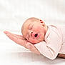 adult_hand, baby, child, closeup, cozy, cute, hand, human, infant, newborn, pastel, peaceful, pink, portrait, resting, skin, sleeping, soft_clothing, tender, white_background