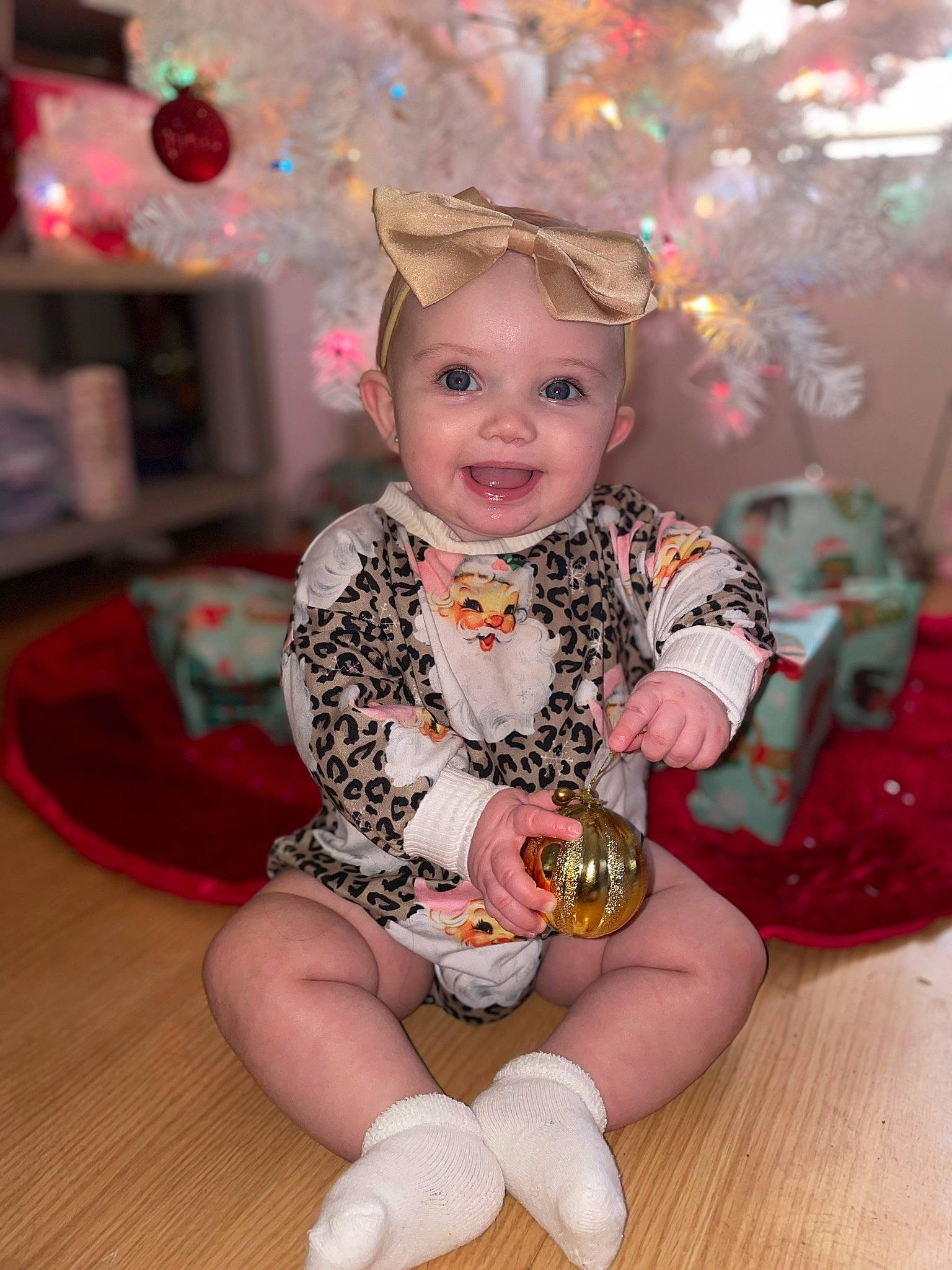 Kinley is registered to the contest to win money with this photo: baby, baby_toddler_clothing, child, christmas, christmas_eve, event, fashion_accessory, fun, happy, holiday, human_leg, joy, party, pattern, person, pink, sitting, sleeve, smile, sock