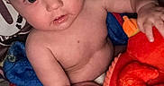 Colton joined the competition — help win amazing prizes! baby, child, toy, plush, red, blanket, tattoo, arm, person, indoor, wide_eyes, curious, skin, holding, seated, closeup, infant, comfort, casual, relaxed