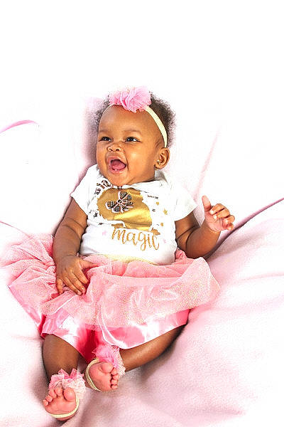 Jade joined the competition — help win amazing prizes! baby, baby_toddler_clothing, cheek, child, dress, face, fashion_accessory, foot, fun, happy, head, headwear, magenta, person, pink, purple, sitting, skin, sleeve, smile