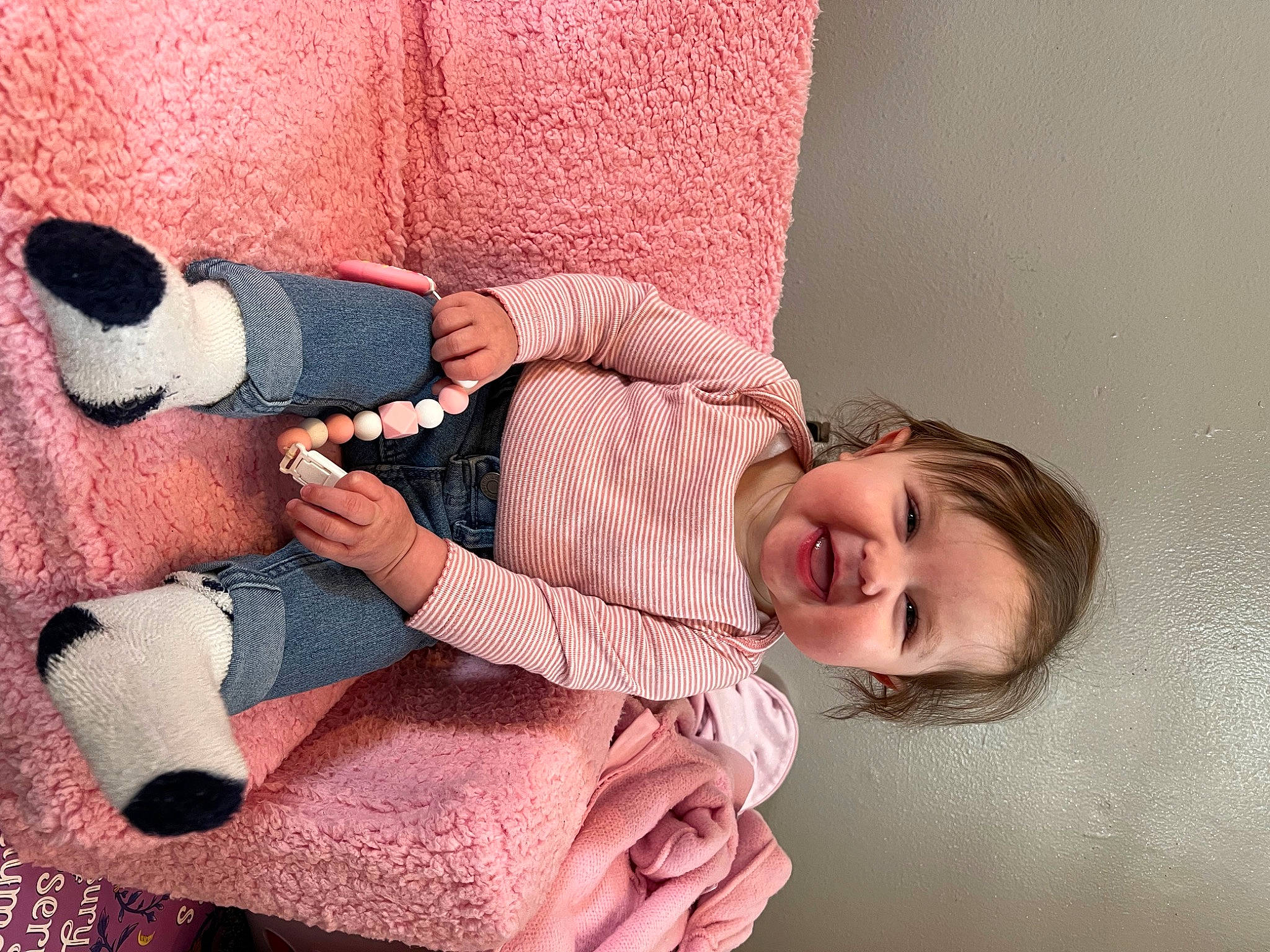 Hazel is registered to the contest to win money with this photo: arm, baby_toddler_clothing, comfort, dress, foot, happy, human_body, human_leg, joint, knee, lap, leg, person, pink, skin, smile, sock, thigh, thumb, toddler