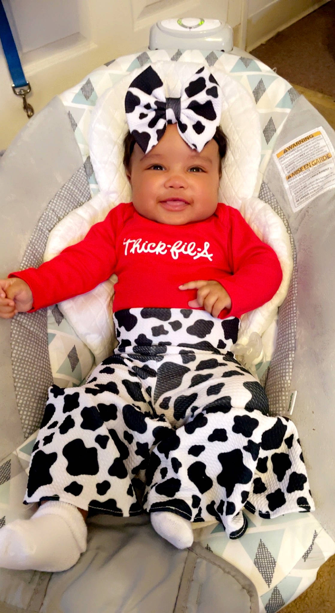 Kamani is registered to the contest to win money with this photo: baby, baby_safety, baby_toddler_clothing, cap, chair, child, comfort, couch, happy, headwear, human_leg, joy, knee, linens, pattern, person, sitting, sleeve, smile, textile