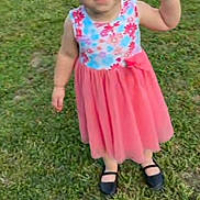 Zoe is registered to the contest to win money with this photo: child, toddler, girl, dress, floral, pink_skirt, black_shoes, grass, outdoor, smiling, standing, cute, young, happy, person, nature, daylight, casual, playful, summer