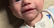 Jaxon joined the competition — help win amazing prizes! baby, infant, smiling, face, blue_blanket, teddy_bear_pattern, soft_texture, cozy, lying_down, cute, child, newborn, warm_light, skin, eyes, clothing, portrait, indoors, close_up, happy