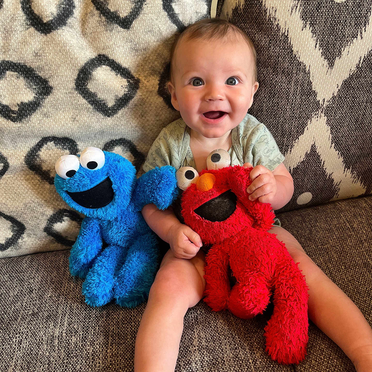 Jensen is registered to the contest to win money with this photo: baby, blanket, bodypart, couch, cushion, face, finger, furniture, hand, happy, head, homedecor, person, photography, plush, portrait, sitting, smile, teddybear, toy