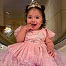 Zarali is registered to the contest to win money with this photo: toddler, child, girl, dress, pink, tiara, smiling, happy, indoor, curly_hair, sitting, sparkle, cute, fashion, portrait, baby, playful, young_child, joyful, person