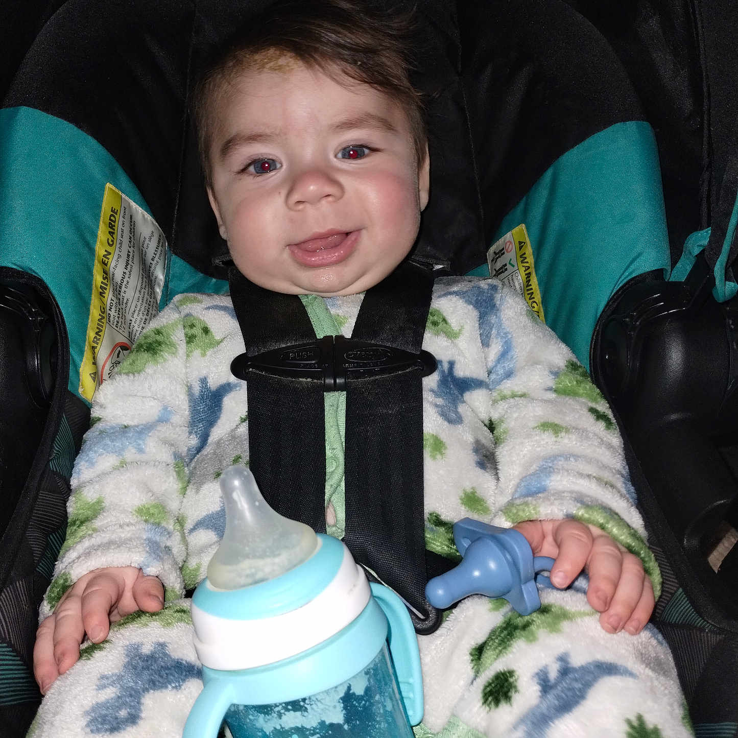 Emerson is registered to the contest to win money with this photo: baby, bodypart, bottle, car, car_interior, carseat, clothing, coat, cushion, face, finger, hand, head, homedecor, person, photography, portrait, transportation, vehicle, waterbottle