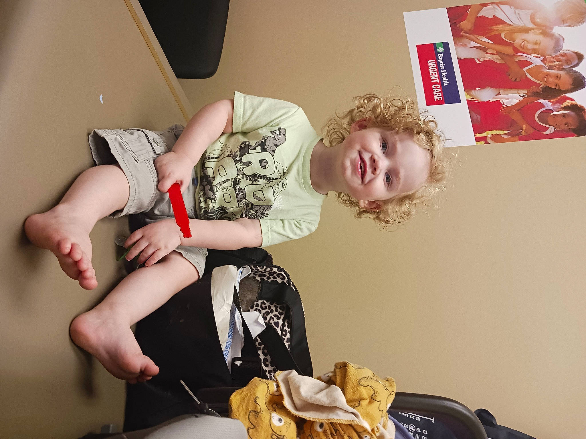 Kolton is registered to the contest to win money with this photo: bag, bread, child, comfort, fashion_design, finger_food, fun, happy, human_leg, joy, knee, luggage_and_bags, person, plate, room, sitting, smile, tableware, thigh, toddler