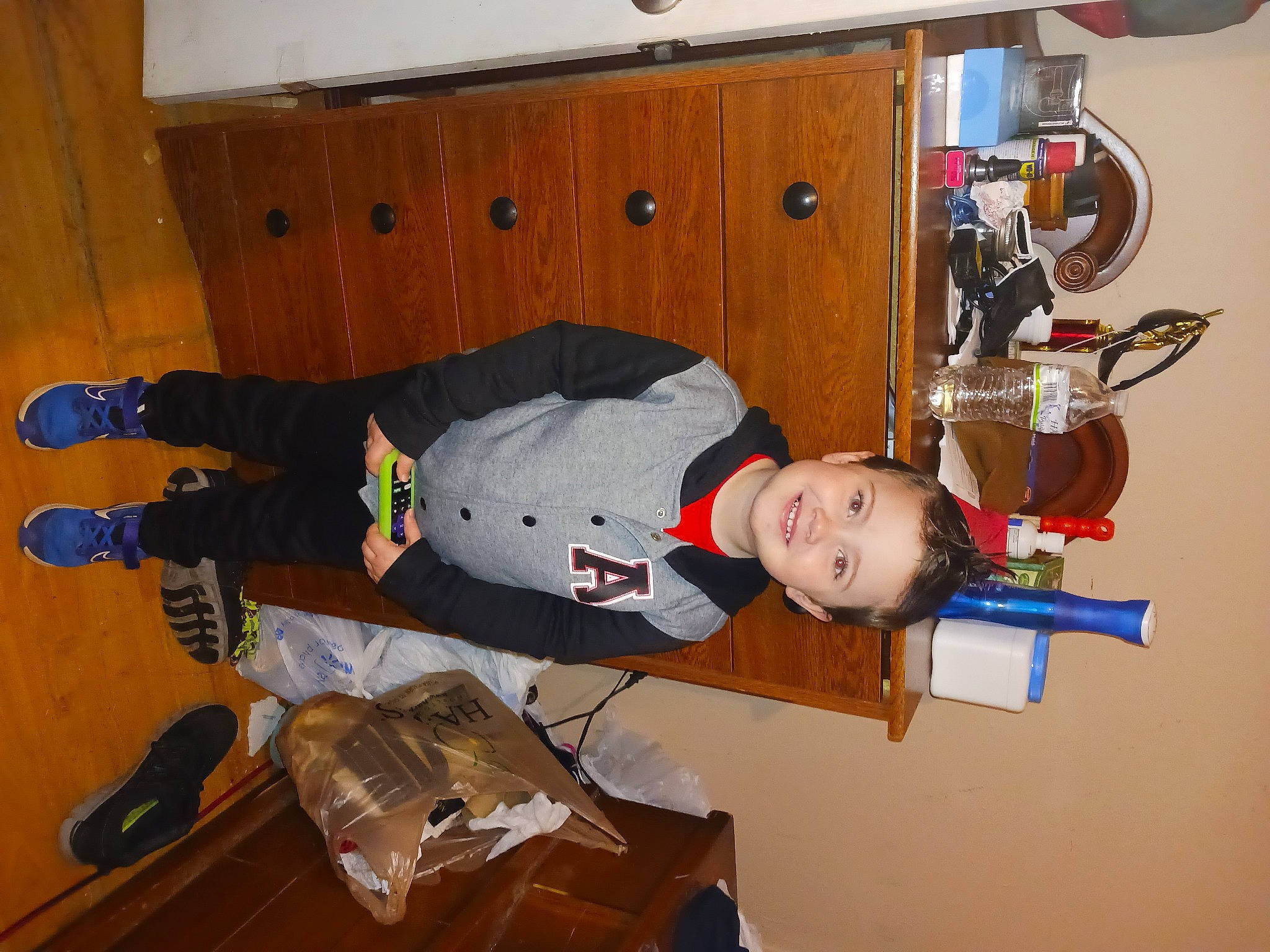 Kaycen joined the competition — help win amazing prizes! baby, boot, child, flooring, fun, hardwood, joy, outdoor_shoe, person, room, sneakers, sock, toddler, walking_shoe, wood