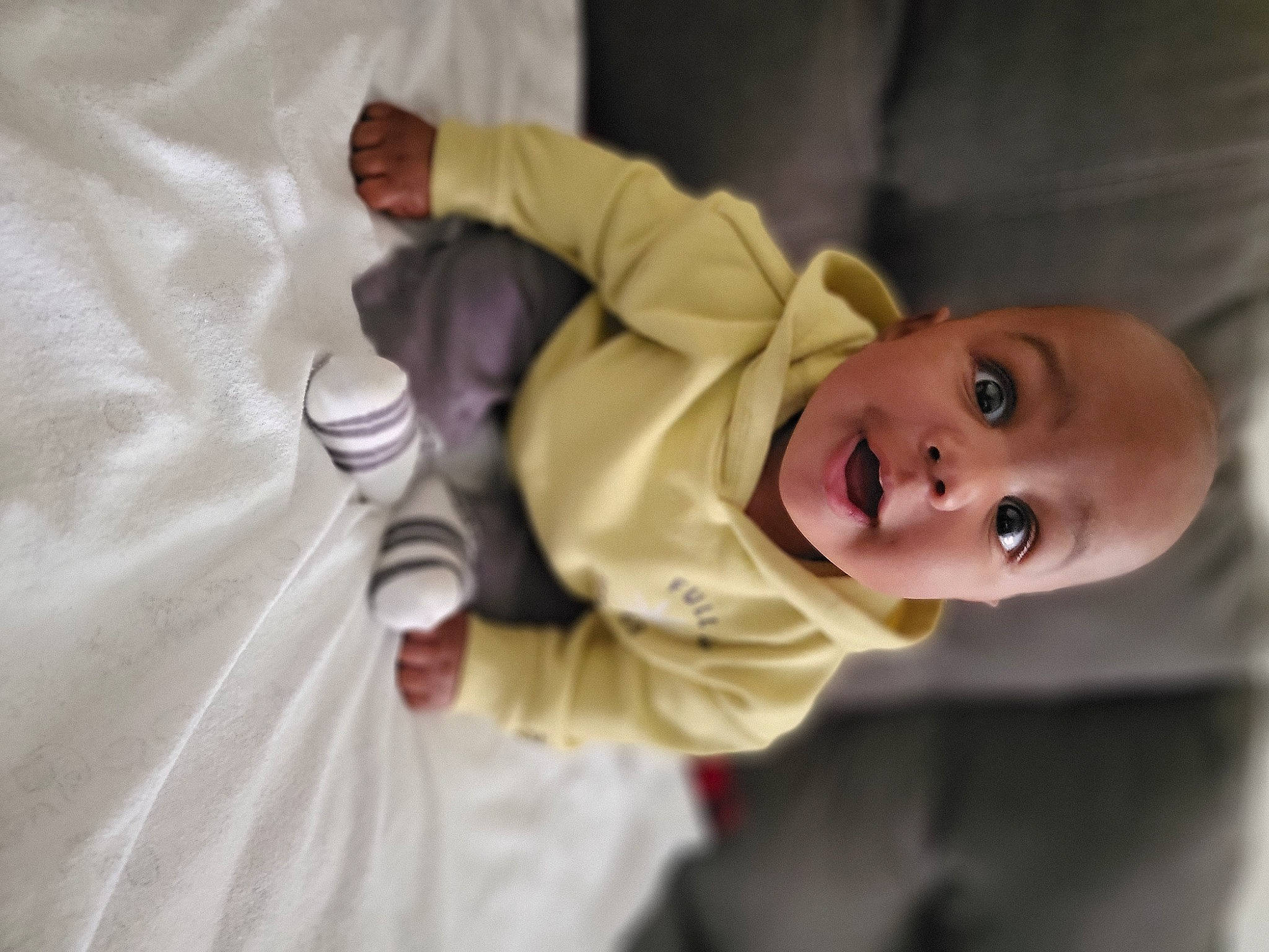 Kendrick is registered to the contest to win money with this photo: baby, baby_products, baby_toddler_clothing, cheek, child, comfort, event, fun, gesture, happy, nose, person, room, sitting, sleeve, smile, suit, surprise, toddler, tree