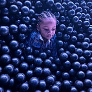 Aydin joined the competition — help win amazing prizes! child, kid, ball_pit, balls, portrait, braided_hair, plaid_shirt, single_person, indoor, play_area, purple_lighting, closeup, face, head, leisure, playful, contemplative, toys, recreation, seated