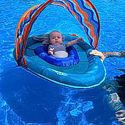 Waylon is registered to the contest to win money with this photo: baby, blue, child, float, floating, fun, hand, infant, outdoor, person, pool, recreation, relaxing, summer, sunshade, support, swimming_pool, swimwear, vacation, water
