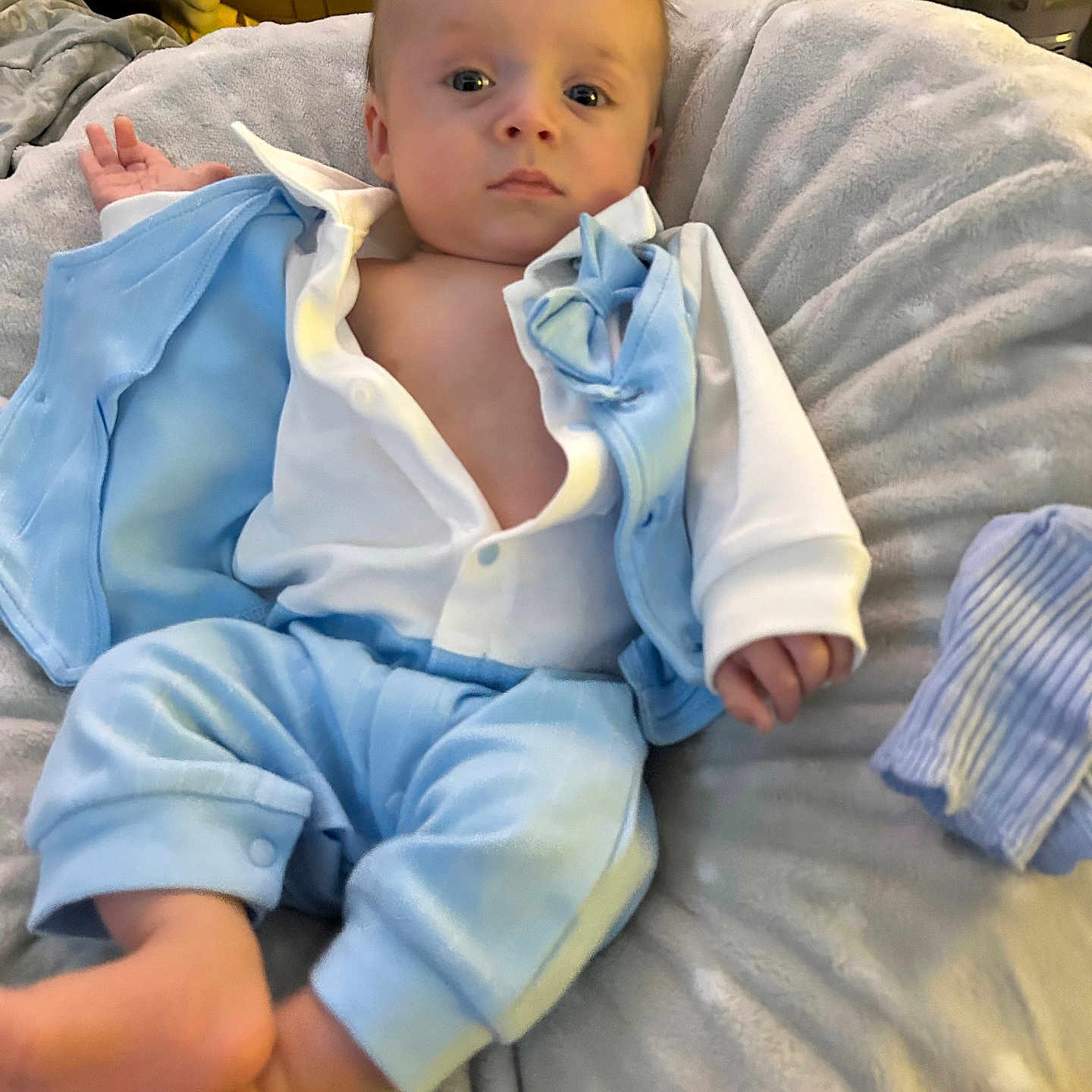 Waylon joined the competition — help win amazing prizes! baby, infant, child, blue_clothing, white_shirt, cushion, blanket, soft_toys, indoor, relaxed, portrait, person, feet, hand, face, head, cozy, laying_down, comfortable, cute