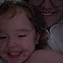 Oaklan is registered to the contest to win money with this photo: child, adult, smiling, face, glasses, hair, indoor, closeup, hug, happy, person, curly_hair, jacket, zipper, skin, cheeks, teeth, candid, affection, warmth