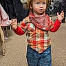 toddler, child, indoor, carpet, plaid_shirt, red_bandana, horned_helmet, viking_hat, cowboy_boots, blue_jeans, walking, costume, young_child, person, cute, curious, determined, clothing, fashion, portrait