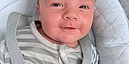 Lyam a rejoint le concours — aidez-le/la à gagner de superbes lots ! baby, infant, face, smile, eyes, pajamas, striped_clothing, seat, safety_strap, pacifier, cushion, closeup, child, cute, indoors, portrait, happy, skin, head, expression