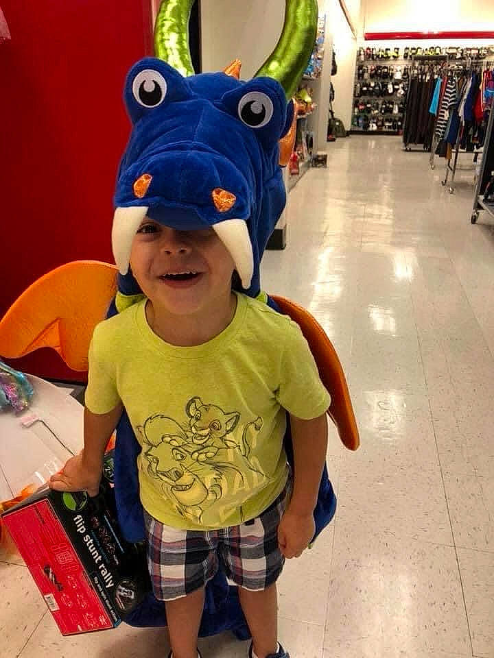 Ian is registered to the contest to win money with this photo: blue, cap, clothing, eye, eyewear, face, finger, floor, fun, green, head, headwear, human, joy, leg, party_supply, people, person, product, recreation