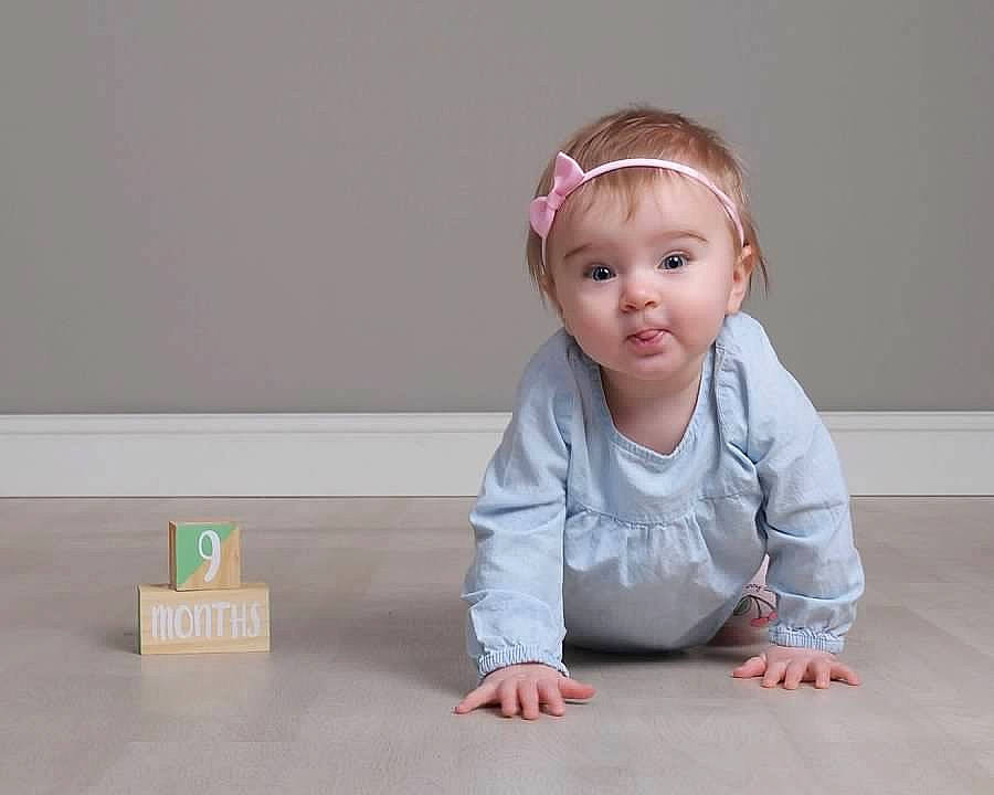 Lilliana joined the competition — help win amazing prizes! baby, child, crawling, floor, flooring, hair_accessory, headband, person, play, sitting, skin, toddler, wood