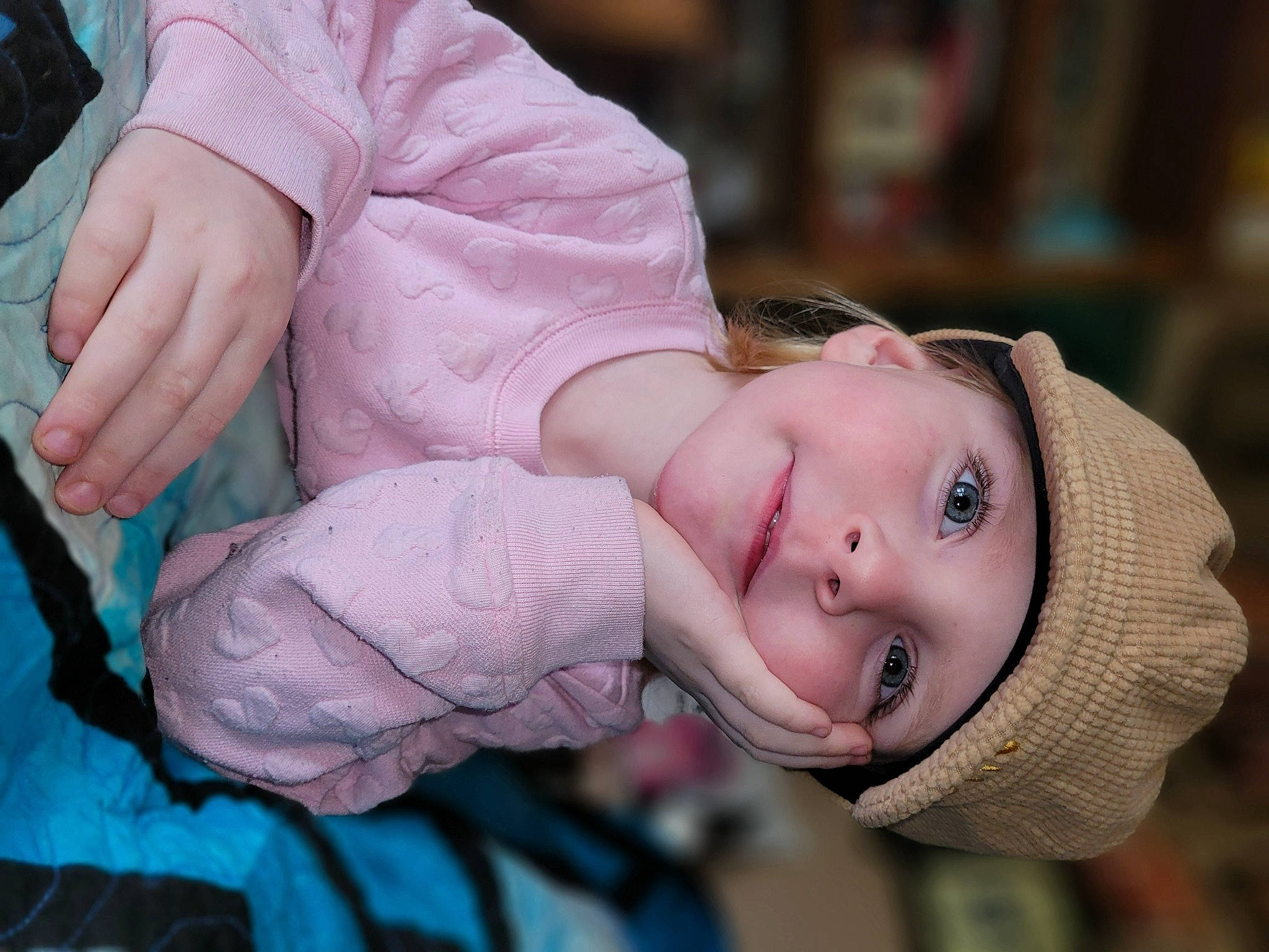 Sage is registered to the contest to win money with this photo: blond, child, eyelash, fashion_accessory, flash_photography, fun, gesture, grass, happy, headwear, jewellery, leisure, lip, mouth, person, portrait_photography, sitting, skin, smile, toddler