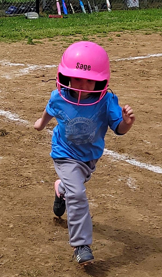 Sage is registered to the contest to win money with this photo: baseball_cap, baseball_equipment, child, electric_blue, fashion_accessory, fun, hard_hat, headwear, helmet, landscape, leisure, magenta, person, personal_protective_equipment, play, sleeve, soil, sports, sports_equipment, sports_gear